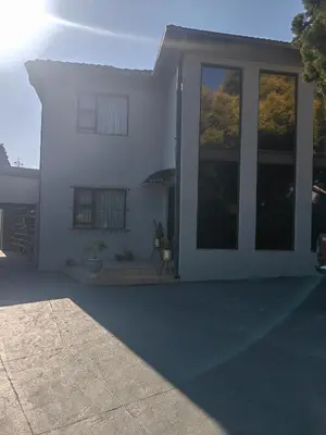 a white house with a large glass door at Choosers Express Boutique Hotel Room 5 in Centurion