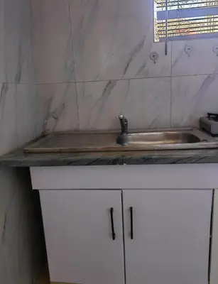 a kitchen counter with a sink and a counter top at Choosers Express Boutique Hotel Room 5 in Centurion
