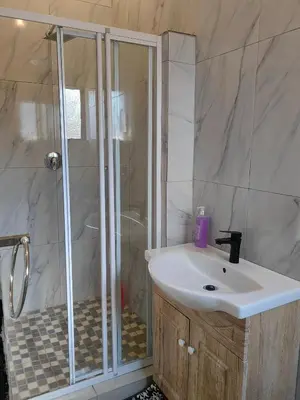 a bathroom with a shower and a white sink at Choosers Express Boutique Hotel Room 5 in Centurion