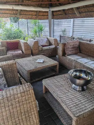 a patio with wicker furniture and a bowl on a table at Choosers Express Boutique Hotel Room 5 in Centurion