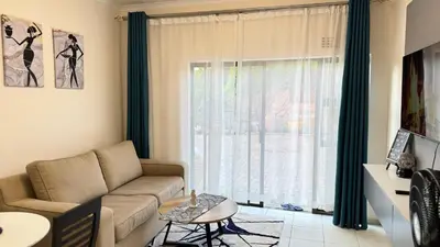 a living room with a couch and a window at Hazel Haven 1 Guest House in Pretoria
