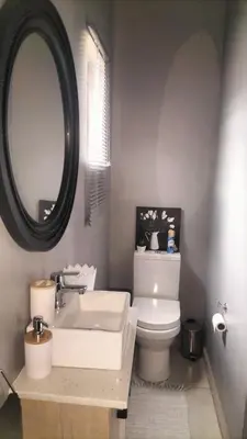 a bathroom with a sink and a toilet and a mirror at J & M Elegant Escape in Centurion
