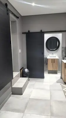 a bathroom with a black door and a sink at J & M Elegant Escape in Centurion