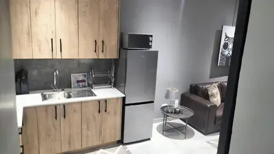 a kitchen with a sink and a refrigerator at J & M Elegant Escape in Centurion