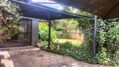 a large blue umbrella over a patio at J & M Elegant Escape in Centurion