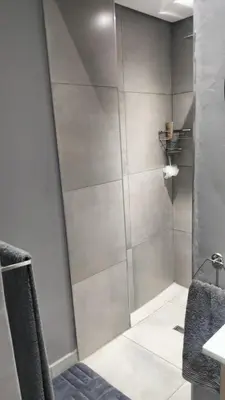 a shower with a glass door in a bathroom at J & M Elegant Escape in Centurion