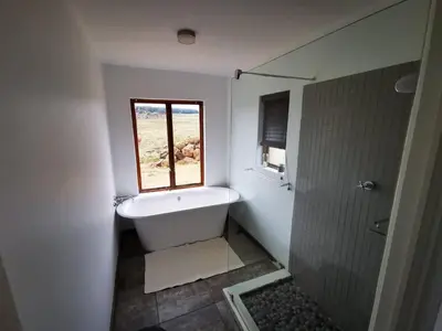 a bathroom with a bath tub and a window at Troutmere in Belfast