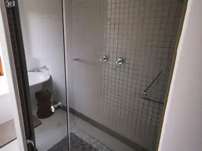 a bathroom with a glass shower with a toilet at Troutmere in Belfast