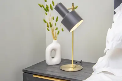 a table with a lamp and a white vase on it at Exclusive Apartment, Ellipse in Midrand