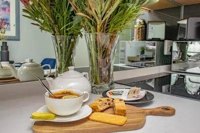 a table with a bowl of soup and a plate of food at Exclusive Apartment, Ellipse in Midrand