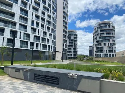 a large building with tall buildings in a city at Exclusive Apartment, Ellipse in Midrand