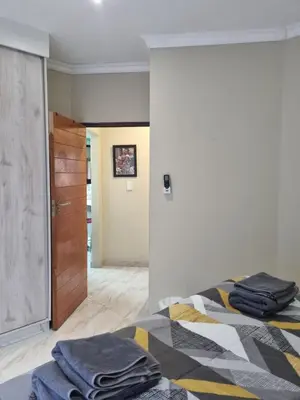 a bedroom with a bed with towels on it at Leetong Holiday Home in Hazyview