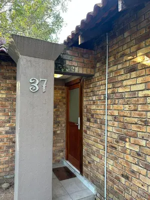 a brick house with a door with the number at Leetong Holiday Home in Hazyview