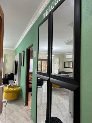a mirror in a room with a living room at Leetong Holiday Home in Hazyview