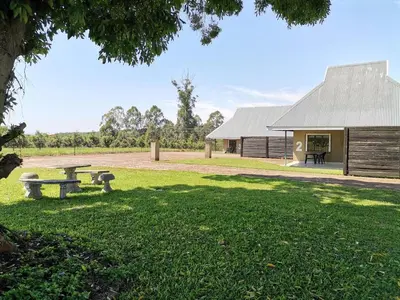 a park with a picnic table and a building at Levubu Junction Lodge in Louis Trichardt