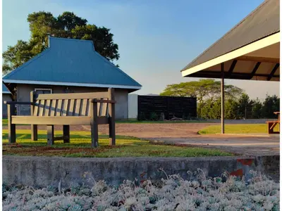 a park bench sitting in front of a building at Levubu Junction Lodge in Louis Trichardt