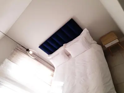 a bed with a blue headboard in a room at The Blyde Crystal Lagoon Penthouse in Avondzon