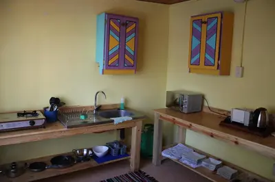 a kitchen with a sink and a counter with a microwave at The Seed Pod Guesthouse in Modimolle