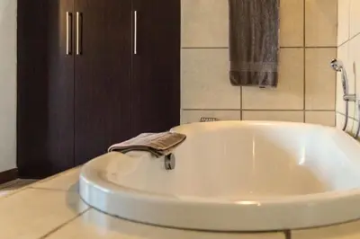 a large white bath tub in a bathroom at Zebula Bush Villa 82, Zebula Golf Estate and Spa in Mabula