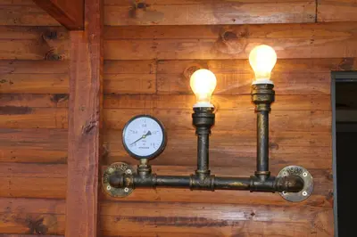 a clock on a wall with two lights at Romantic cabin in Big 5 Reserve in Dinokeng Game Reserve