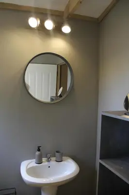 a bathroom with a sink and a mirror on the wall at Romantic cabin in Big 5 Reserve in Dinokeng Game Reserve