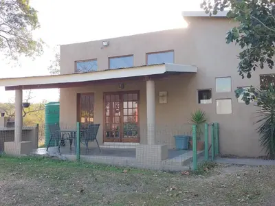 a house with a table and chairs in front of it at The Sanctuary- Self Catering Accommodation in Nelspruit