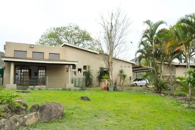 a house with a car parked in front of it at The Sanctuary- Self Catering Accommodation in Nelspruit