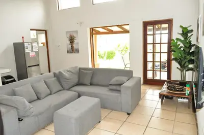 a living room with a couch and a table at The Sanctuary- Self Catering Accommodation in Nelspruit