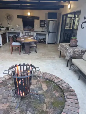 a fire pit in the middle of a living room at Heavenly Hideaway Accommodation in Kampersrus AH