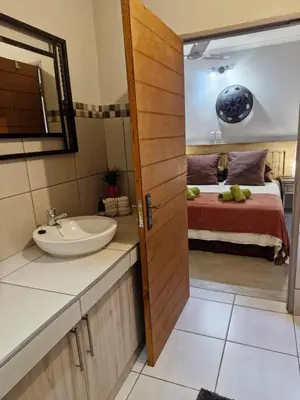 a bathroom with a sink and a bed at Heavenly Hideaway Accommodation in Kampersrus AH