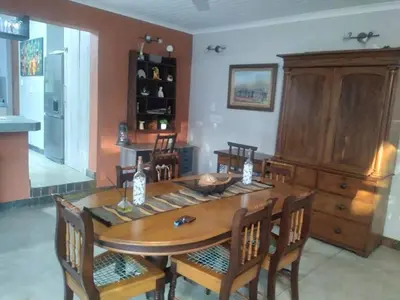 a dining room with a wooden table and chairs at Heavenly Hideaway Accommodation in Kampersrus AH