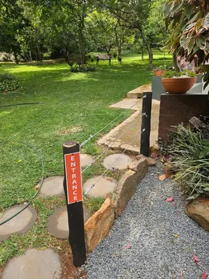 a sign on a path in a park at Heavenly Hideaway Accommodation in Kampersrus AH