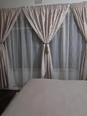 a close up of a bed with a curtain at 15 Kameeldoring 2-bedroomed self-catering unit, Clubview in Centurion