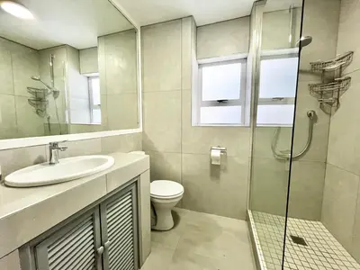 a bathroom with a sink and a toilet and a shower at Thornhill Tranquility in Pretoria