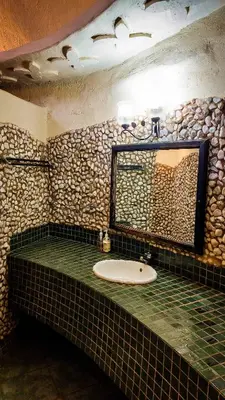 a bathroom with a sink and a mirror at Kianga Lodge & Venue in Centurion