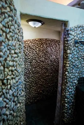 a hallway with a stone wall with a light on it at Kianga Lodge & Venue in Centurion