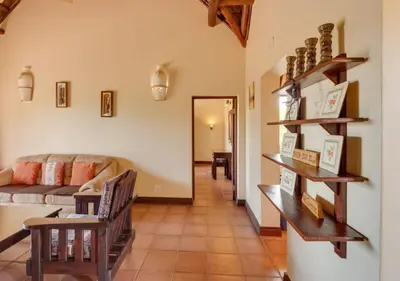 a living room with a couch and a table at 205 Zebula 4 Bedroom with 2 bedroom Cottage in Mabula