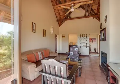 a living room with a couch and a table at 205 Zebula 4 Bedroom with 2 bedroom Cottage in Mabula