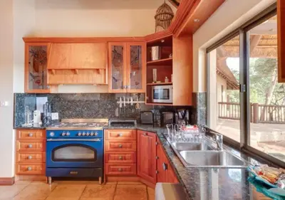 a kitchen with a blue stove and a sink at 205 Zebula 4 Bedroom with 2 bedroom Cottage in Mabula