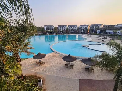 a large swimming pool with umbrellas in a resort at The Blyde Bliss in Pretoria