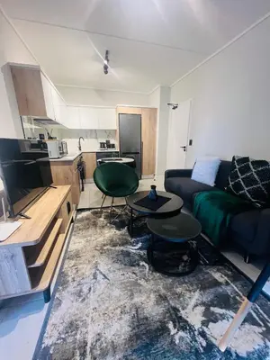 a living room with a couch and a table at The Blyde Bliss in Pretoria