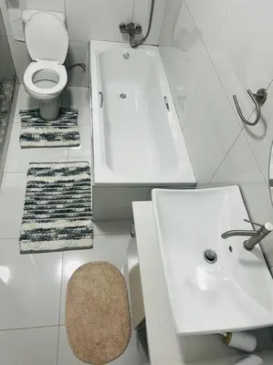 a white bathroom with a sink and a toilet at KT Space in Midrand