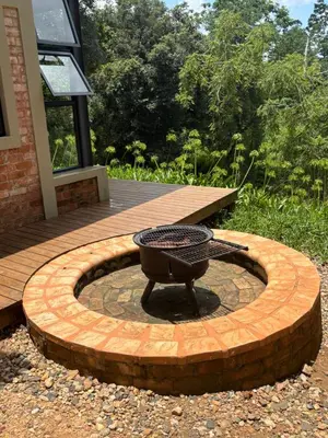 a fire pit in the middle of a patio at Modern Apartment on Letaba River in Tzaneen