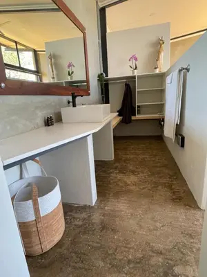 a bathroom with a sink and a mirror at Modern Apartment on Letaba River in Tzaneen