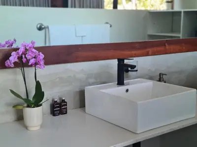 a white sink on a counter in a bathroom at Modern Apartment on Letaba River in Tzaneen