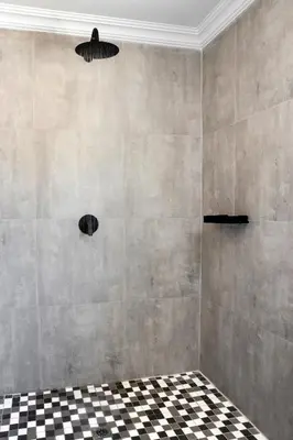 a bathroom with a black and white checkered floor at Woman Era Guesthouse in Midrand