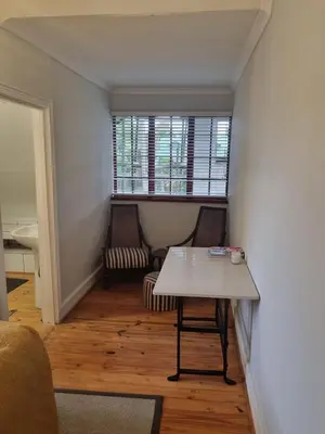 a living room with a table and a window at The Jones in Kaapsehoop