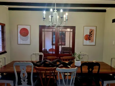 a dining room table with chairs and a chandelier at The Jones in Kaapsehoop