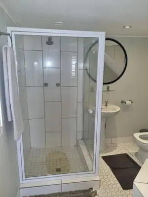 a bathroom with a shower and a toilet and a sink at The Jones in Kaapsehoop