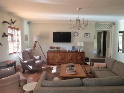 a living room with a couch and a tv at The Jones in Kaapsehoop